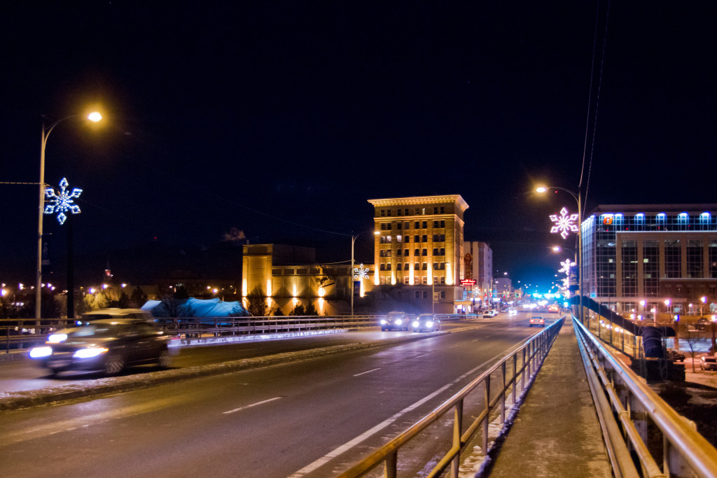The Higgins Street Bridge on a winter night in Downtown Missoula with the snowflakes lit up.