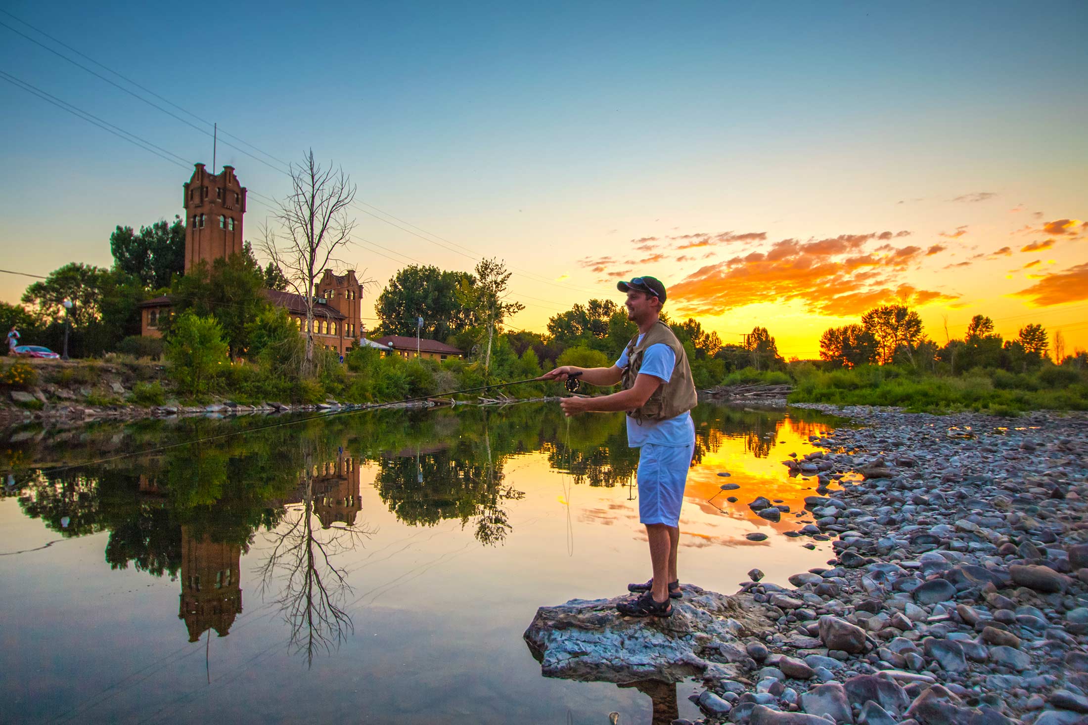 A fly fisherman casting a line into the Clark Fork River in Downtown Missoula